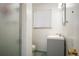 Clean bathroom featuring a stand-up shower with glass door and a modern vanity with a sleek countertop at 1492 S Dudley St, Lakewood, CO 80232