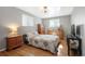 Cozy bedroom featuring hardwood floors, large windows, and neutral color palette at 1492 S Dudley St, Lakewood, CO 80232