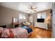 Comfortable bedroom featuring a ceiling fan, hardwood floors, and a charming wicker chair with a cozy cushion at 1492 S Dudley St, Lakewood, CO 80232