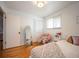 Well-lit bedroom with a large mirror, closet, and a cozy chair with a plush teddy bear at 1492 S Dudley St, Lakewood, CO 80232