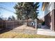 A secure fenced dog run with gravel and grass provides a safe outdoor space for pets at 1492 S Dudley St, Lakewood, CO 80232
