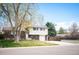 Charming two-story home with brick and siding exterior, mature tree, and well-maintained front yard at 1492 S Dudley St, Lakewood, CO 80232