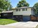 Charming two-story home with brick and siding, featuring a well-maintained front yard and blue accents at 1492 S Dudley St, Lakewood, CO 80232