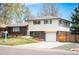 Charming two-story home featuring brick accents, a well-maintained lawn, and a two car garage at 1492 S Dudley St, Lakewood, CO 80232
