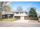 Charming home featuring a well-maintained lawn, brick accents, and a two-car garage at 1492 S Dudley St, Lakewood, CO 80232