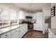 Renovated kitchen with modern appliances, granite counters, and ample cabinet space at 1492 S Dudley St, Lakewood, CO 80232