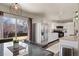Eat-in kitchen and dining area with stainless steel refrigerator and sliding glass door at 1492 S Dudley St, Lakewood, CO 80232