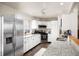 Bright kitchen features stainless steel appliances, granite countertops, and white cabinetry at 1492 S Dudley St, Lakewood, CO 80232