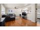 Open living room with hardwood floors and a large sectional sofa with a ceiling fan at 1492 S Dudley St, Lakewood, CO 80232