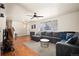 Inviting living room featuring hardwood floors, a comfortable sectional, and ample natural light at 1492 S Dudley St, Lakewood, CO 80232