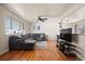 Bright and inviting living room with hardwood floors, a large sectional sofa, and plenty of natural light at 1492 S Dudley St, Lakewood, CO 80232