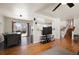 Open-concept living room with hardwood floors seamlessly connecting to the dining area and kitchen at 1492 S Dudley St, Lakewood, CO 80232