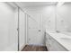 Bright bathroom featuring double vanity, white cabinets, and a walk-in shower with glass door at 2145 Flower Blossom Ave, Brighton, CO 80601