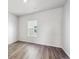 Cozy bedroom with wood flooring, a window, and ample natural light at 2145 Flower Blossom Ave, Brighton, CO 80601