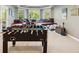 Finished basement showcasing a foosball table, drum set, keyboard, and window seat for relaxation at 11302 E Ida Ct, Englewood, CO 80111