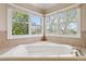 Serene bathroom featuring a soaking tub with picturesque outdoor views at 11302 E Ida Ct, Englewood, CO 80111