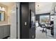 Bright bathroom featuring a vanity with gray cabinets and modern fixtures adjacent to a bedroom/office at 11302 E Ida Ct, Englewood, CO 80111