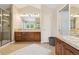Bathroom with dual vanities, tile floors, and glass shower at 11302 E Ida Ct, Englewood, CO 80111