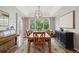 Elegant dining room with large windows and hardwood floors, perfect for entertaining at 11302 E Ida Ct, Englewood, CO 80111