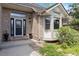 Charming brick home entrance with a black front door, bay window, and well-maintained landscaping at 11302 E Ida Ct, Englewood, CO 80111