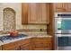 Gourmet kitchen features a gas cooktop, stainless steel appliances, and granite countertops at 11302 E Ida Ct, Englewood, CO 80111