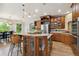 Gourmet kitchen with a large island, granite countertops, stainless steel appliances, and custom cabinetry at 11302 E Ida Ct, Englewood, CO 80111