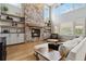 Inviting living room with a grand stone fireplace, floating shelves, and natural light, creating a warm atmosphere at 11302 E Ida Ct, Englewood, CO 80111