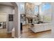Spacious living room featuring a floor-to-ceiling stone fireplace, open shelving, and hardwood floors at 11302 E Ida Ct, Englewood, CO 80111