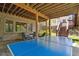 Covered outdoor patio with a ping pong table and seating area, offering a great space for recreation at 11302 E Ida Ct, Englewood, CO 80111
