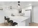 Stylish basement bar with white cabinets, quartz countertops, and modern lighting at 8188 S Yukon St, Littleton, CO 80128