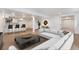 Spacious basement living room with modern bar, light wood floors, and stylish décor at 8188 S Yukon St, Littleton, CO 80128