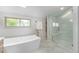 Bathroom featuring soaking tub, glass shower, and double vanity at 8188 S Yukon St, Littleton, CO 80128