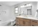 Bathroom with modern vanity, stylish fixtures, shower-tub combo, and tiled walls at 8188 S Yukon St, Littleton, CO 80128
