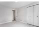 Neutral bedroom with closet, carpet, and a door to the bathroom at 8188 S Yukon St, Littleton, CO 80128