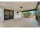 Covered patio with wood decking, black railing, and sliding glass doors to indoors at 8188 S Yukon St, Littleton, CO 80128