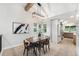 Bright dining room featuring a modern light fixture and views into the kitchen at 8188 S Yukon St, Littleton, CO 80128