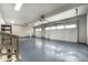 Large two-car garage featuring painted floors and overhead lighting at 8188 S Yukon St, Littleton, CO 80128