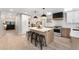Modern kitchen features a center island with quartz countertops, breakfast bar, and stainless steel appliances at 8188 S Yukon St, Littleton, CO 80128