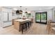 Bright kitchen with a center island, modern cabinets, pendant lights, and an adjacent breakfast nook at 8188 S Yukon St, Littleton, CO 80128