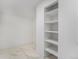 An empty walk-in closet with marble floor and white shelving at 8188 S Yukon St, Littleton, CO 80128