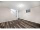 Spacious basement area featuring hardwood floors, natural lighting, and access to an upper level at 12662 W Virginia Ave, Lakewood, CO 80228