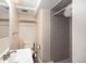 Full bathroom including gray tiled shower, modern sink, towel rack, and standard toilet at 12662 W Virginia Ave, Lakewood, CO 80228