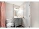 Clean bathroom featuring gray vanity, white toilet, vanity mirror, and ample lighting at 12662 W Virginia Ave, Lakewood, CO 80228