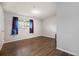Bright bedroom with hardwood floors, fresh paint, and natural light from the window at 12662 W Virginia Ave, Lakewood, CO 80228