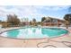 Large community pool surrounded by residential housing and a modern building with a brick facade at 12662 W Virginia Ave, Lakewood, CO 80228