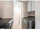 Laundry room equipped with modern washer and dryer units and storage cabinets at 12662 W Virginia Ave, Lakewood, CO 80228