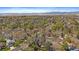 A high-angle view of a residential area showcases the uniform roofs, roads and sprawling neighborhood and mountains at 8508 Vivian Ct, Arvada, CO 80005