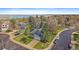A high-angle view shows homes with well-manicured lawns near a tranquil lake, offering a suburban living experience at 8508 Vivian Ct, Arvada, CO 80005