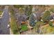 Aerial view of a home with a wooden deck and large backyard in a neighborhood with mature trees at 8508 Vivian Ct, Arvada, CO 80005