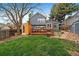 The lush backyard features a deck, a sauna, a grass area, and a two-story blue home at 8508 Vivian Ct, Arvada, CO 80005